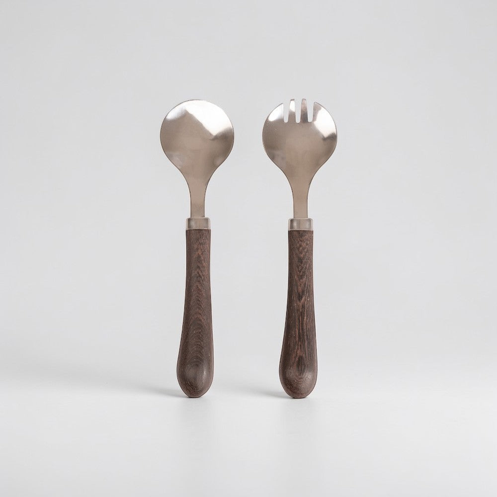 aelgmark Astrid stainless steel salad servers with dark wood handles, one spoon and one fork.