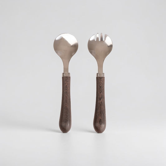 aelgmark Astrid stainless steel salad servers with dark wood handles, one spoon and one fork.