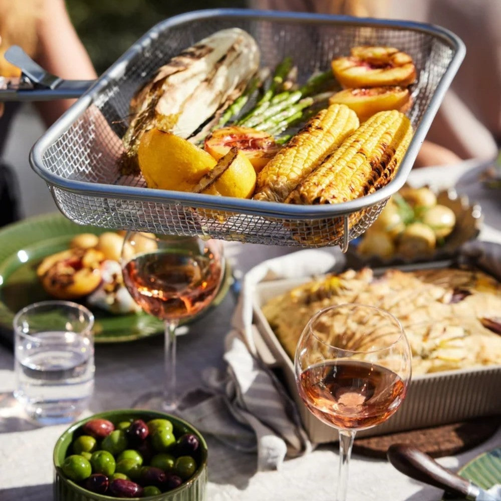 aelgmark Fredde BBQ grill basket with corn, asparagus, peaches, and lemon. Detachable wooden handle.