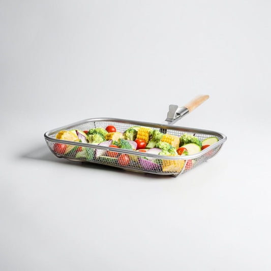 Aelgmark Fredde BBQ grill basket with removable wooden handle, filled with corn, broccoli, tomatoes, and red onion.