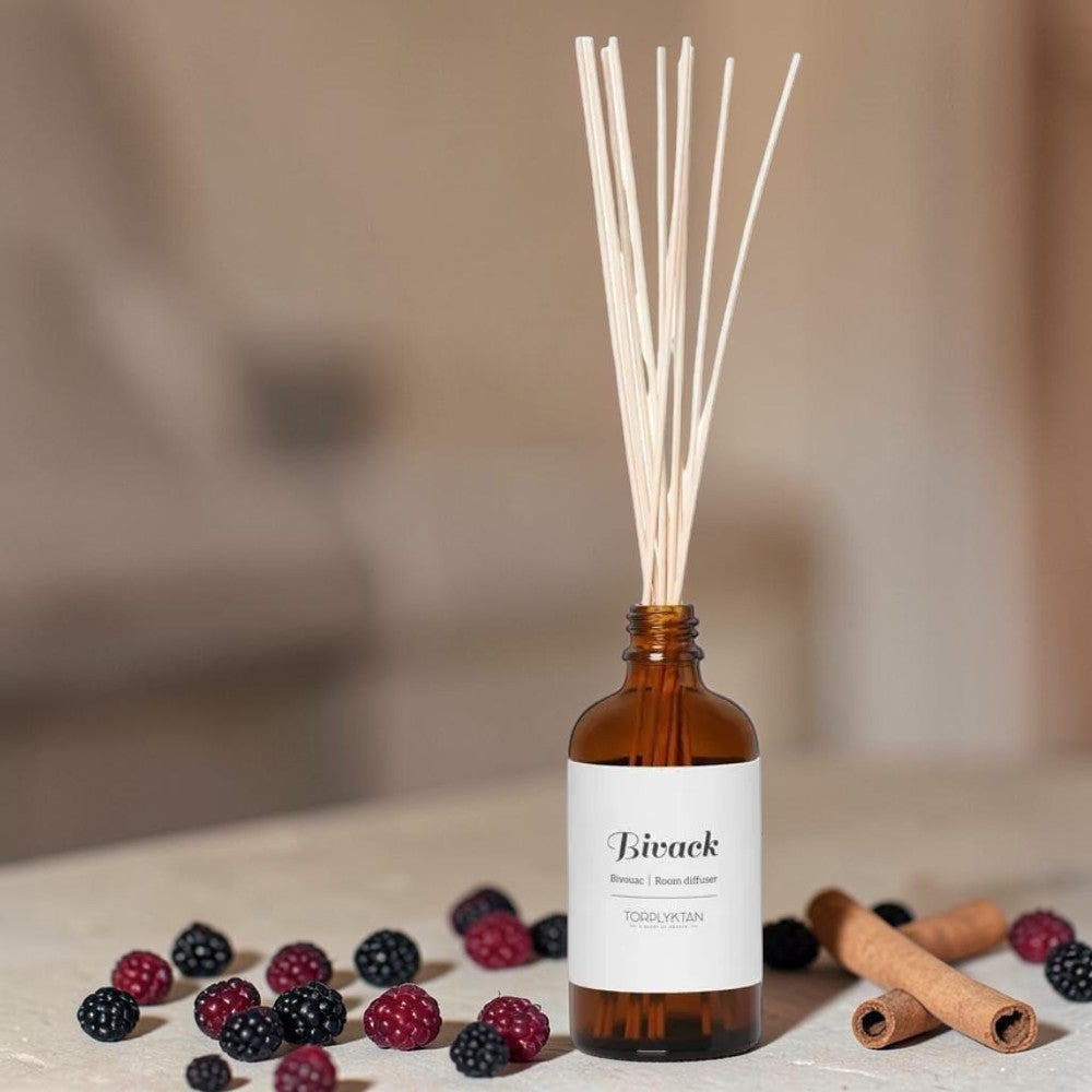 aelgmark Bivack room diffuser with cinnamon and blackberry scent in amber glass bottle with reeds.