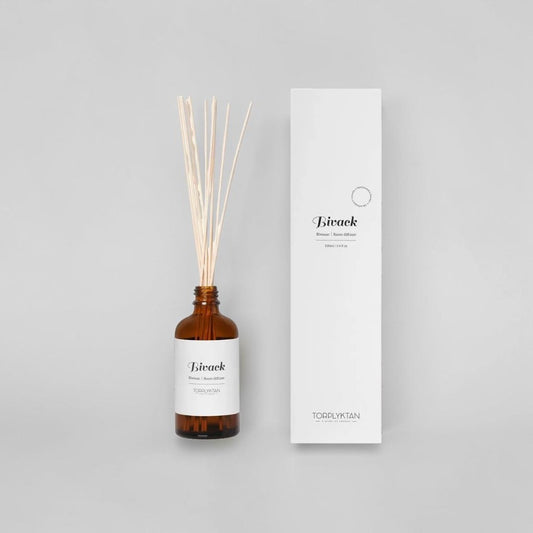 aelgmark Bivack room diffuser with cinnamon and blackberry scent in amber glass bottle with reeds.