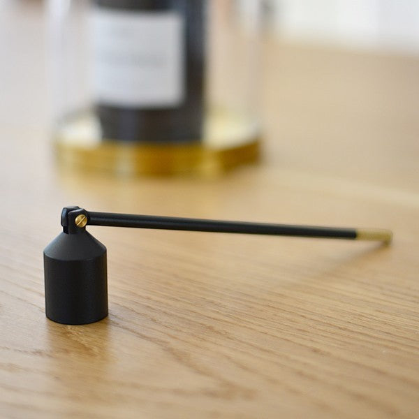 aelgmark black metal candle snuffer with brass accent, elegant minimalist design.