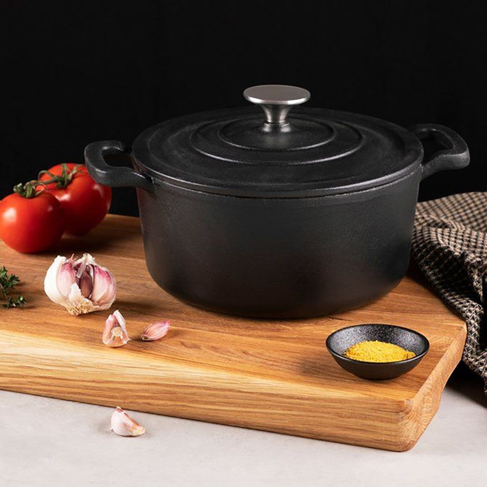 aelgmark black cast iron Dutch oven with lid, ideal for slow cooking and braising. Features self-basting condensation bumps.