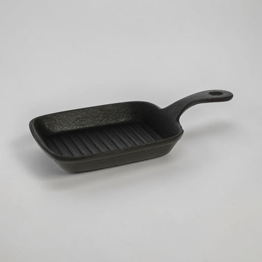aelgmark black cast iron single-serving grill pan with ridged surface and handle.