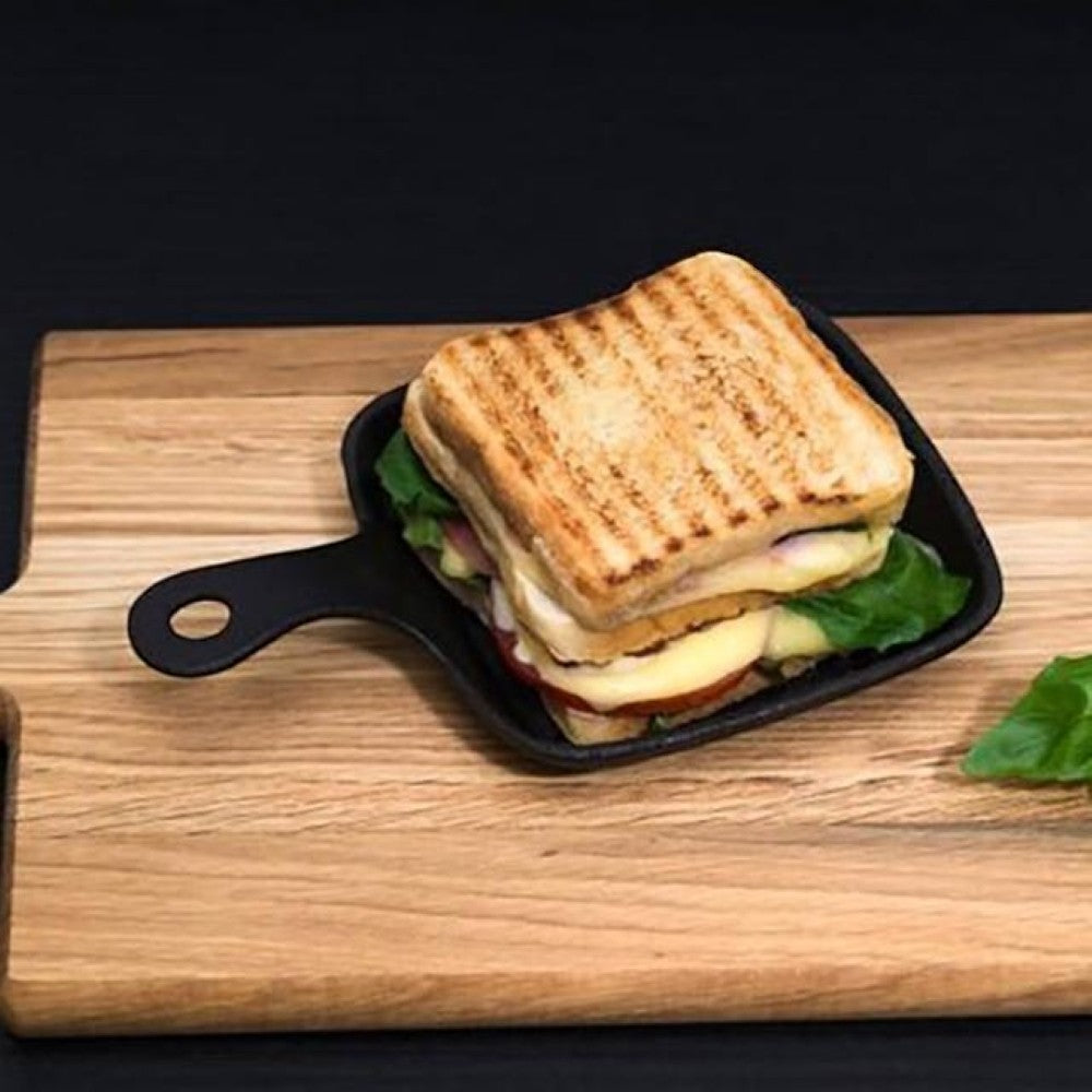 aelgmark black cast iron single serving grill pan with a grilled sandwich