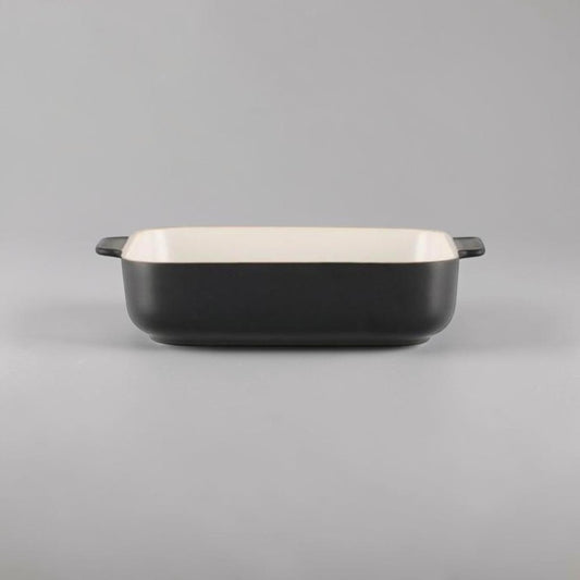 Aelgmark black ceramic baking dish with cream interior and side handles. Rectangular shape, ideal for oven use.