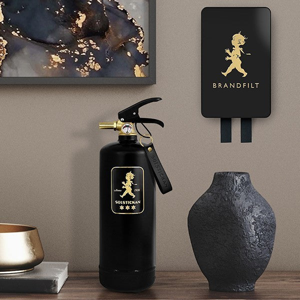 aelgmark black fiberglass fire blanket 120x120cm in a decorative steel box with a child emblem. Includes extinguisher.