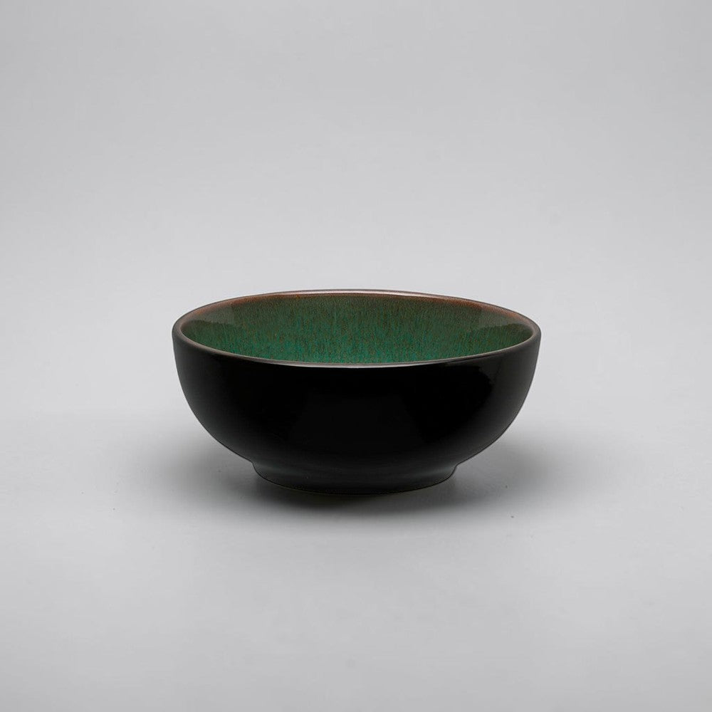 Aelgmark black ceramic bowl with a glossy green interior glaze and a subtle brown rim.
