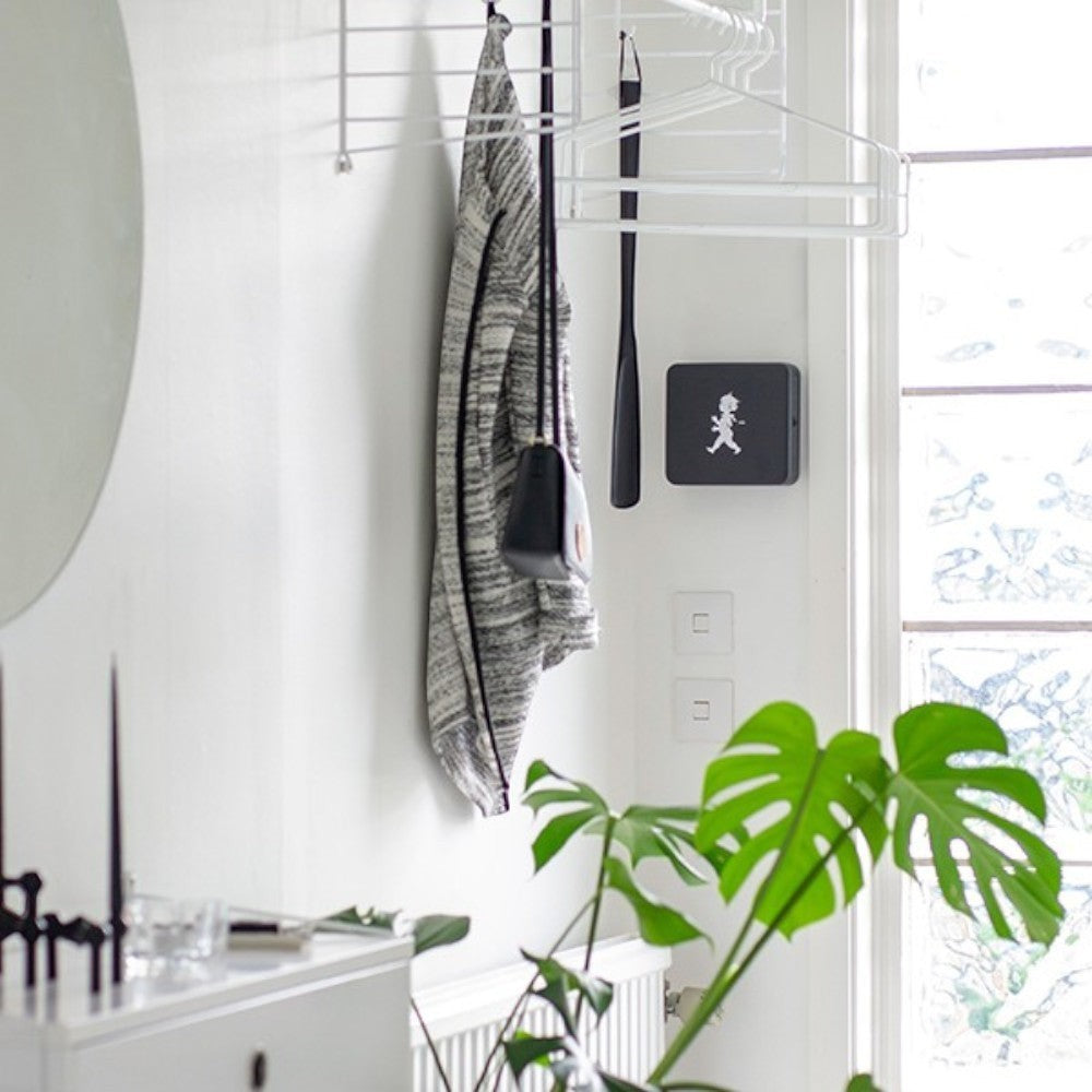 aelgmark black wall-mounted key holder with a boy graphic, perfect for entryway organization.
