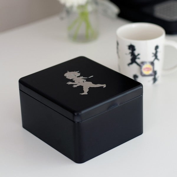 aelgmark black metal storage tin with a silver running boy emblem, ideal for tea bags or small items.