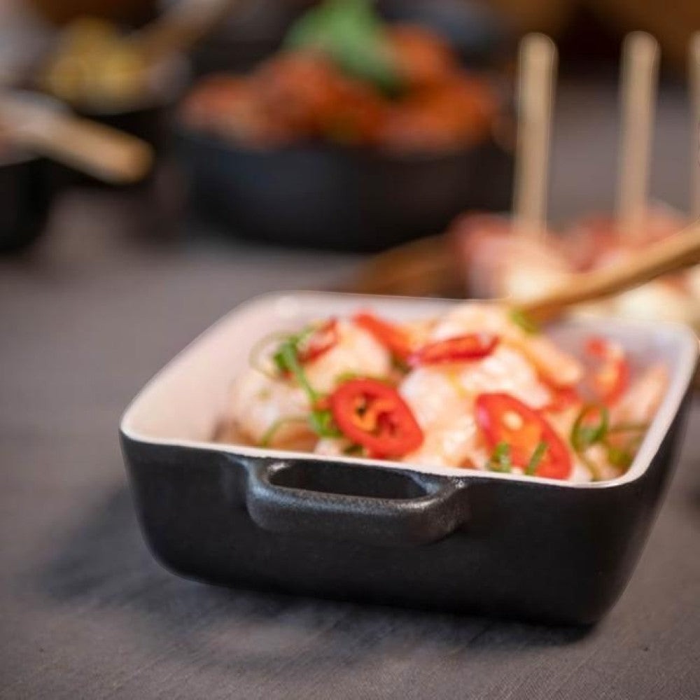 aelgmark black oven-safe ramekin dish with handles, perfect for baking desserts or serving appetizers.