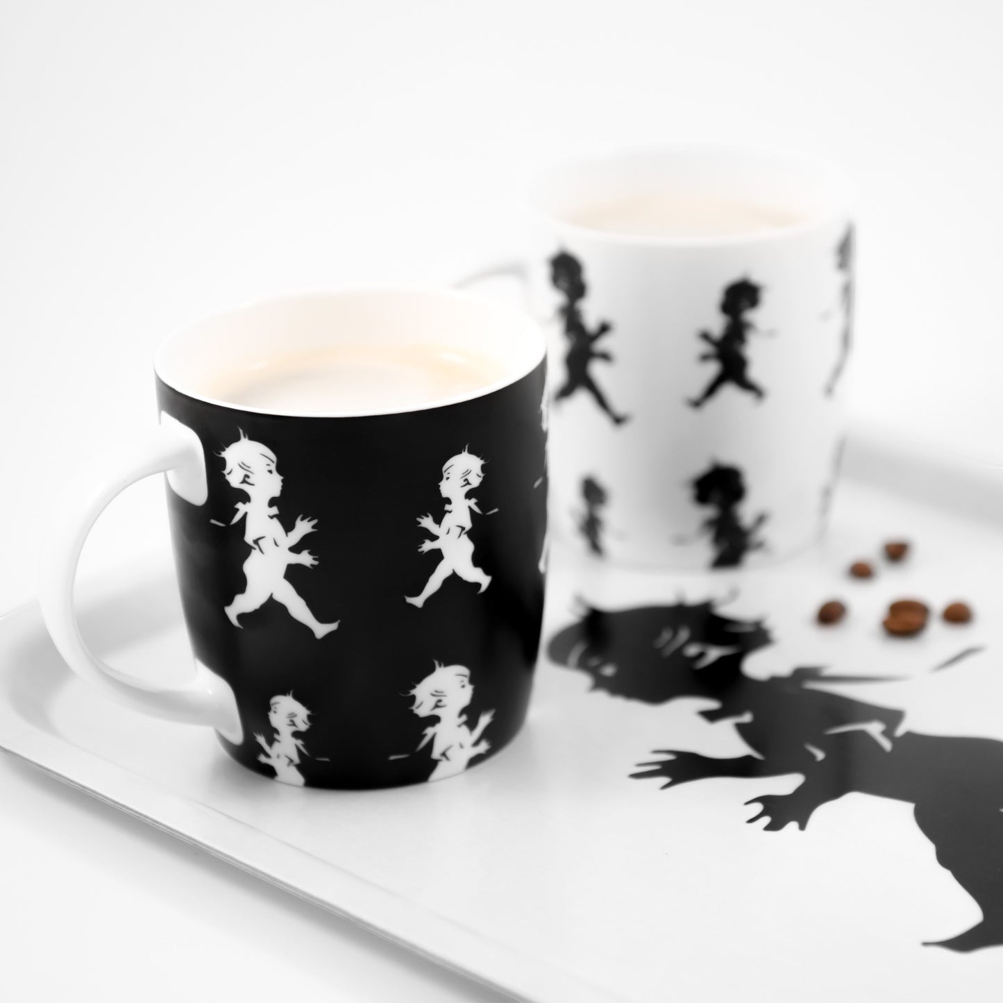 aelgmark black ceramic mug with white running boy graphic, 380ml capacity, part of a set with a white mug.