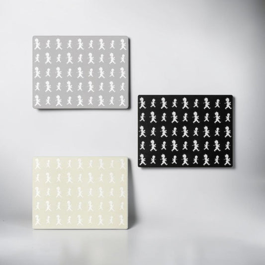 aelgmark placemats feature a repeating pattern of a boy in white on grey, black, and beige backgrounds.