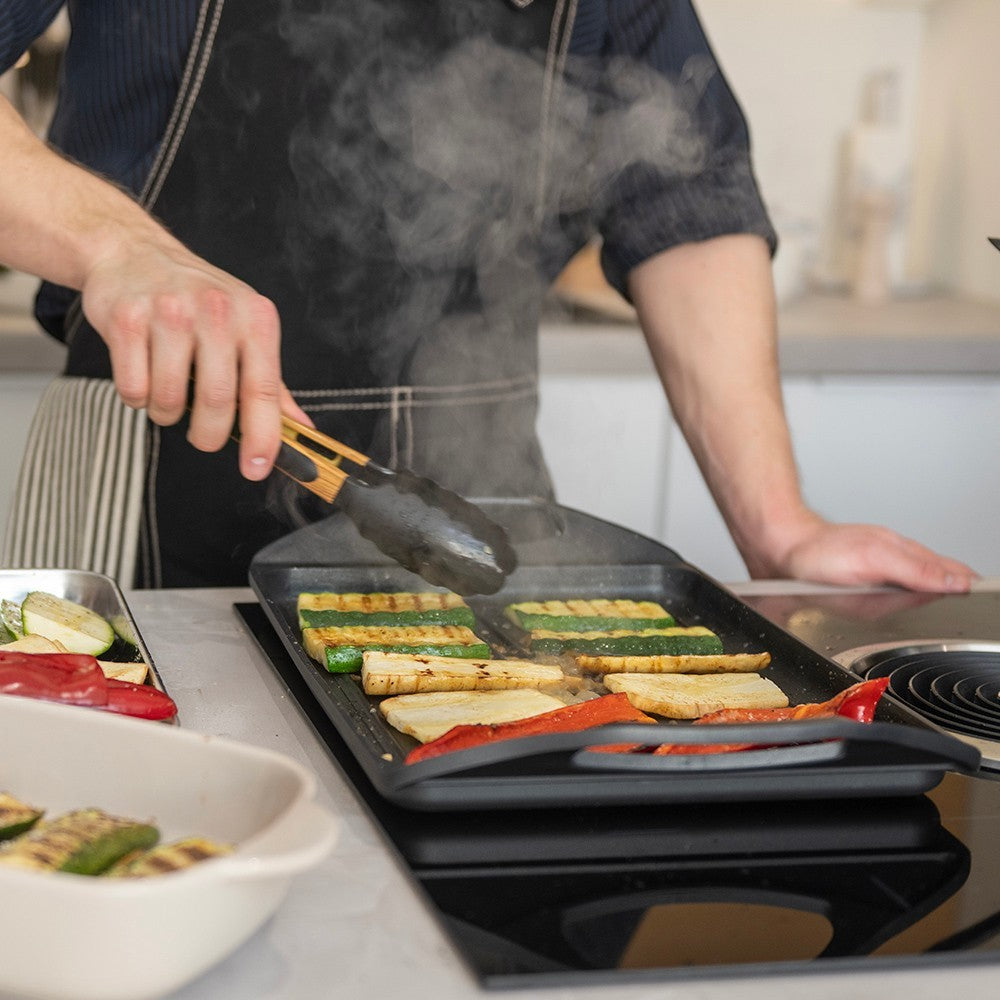 aelgmark cast aluminum non-stick grill pan with zucchini, tofu, and red peppers cooking