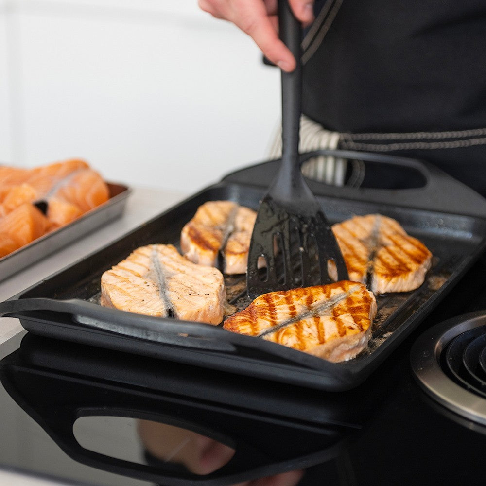 aelgmark cast aluminum non-stick grill pan cooking salmon steaks with grill marks. Easy clean, fast heat.