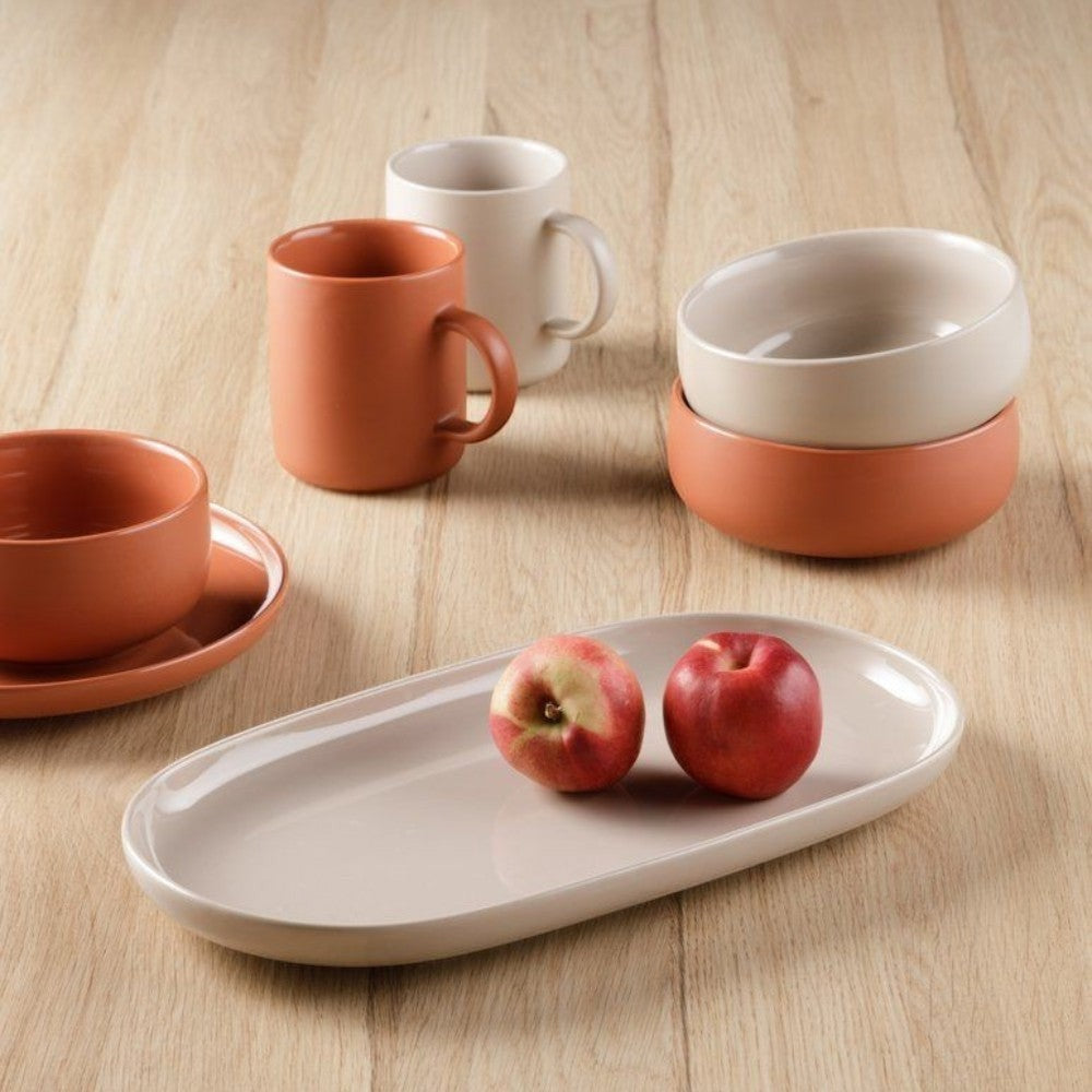 aelgmark ceramic bowls and mugs in terracotta and cream, oval serving platter with apples.