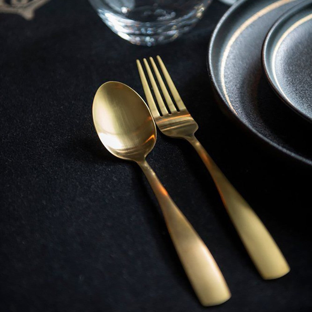 Aelgmark champagne gold stainless steel cutlery set, including a spoon and fork, with a matte finish.