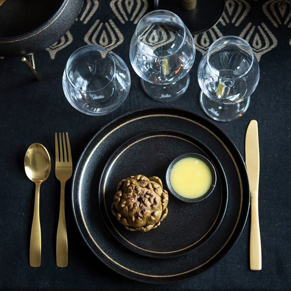 aelgmark champagne gold stainless steel cutlery set with black plates and wine glasses