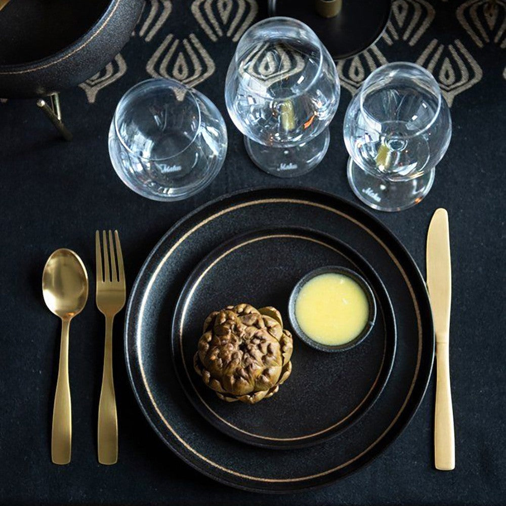aelgmark champagne gold stainless steel cutlery set with black plates and wine glasses