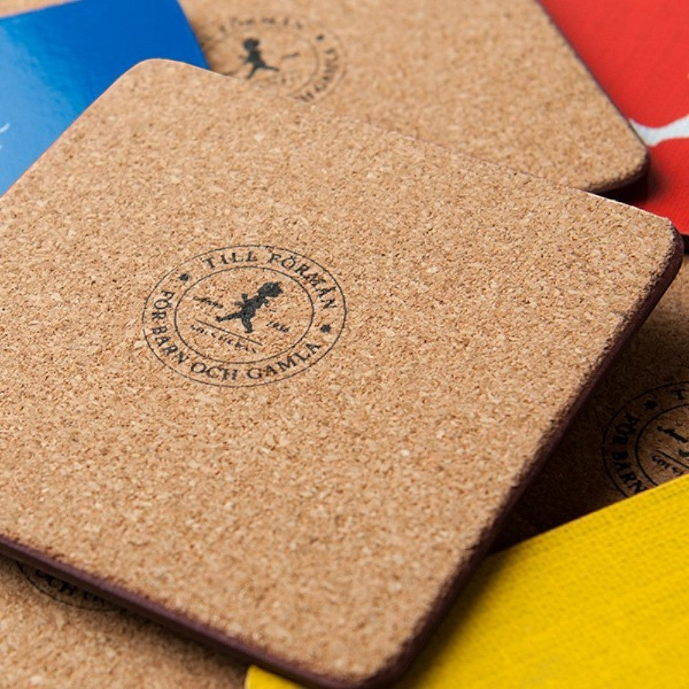 aelgmark cork coasters featuring a vintage Solstickan boy logo in black, sold in a set of 4 in assorted colors.