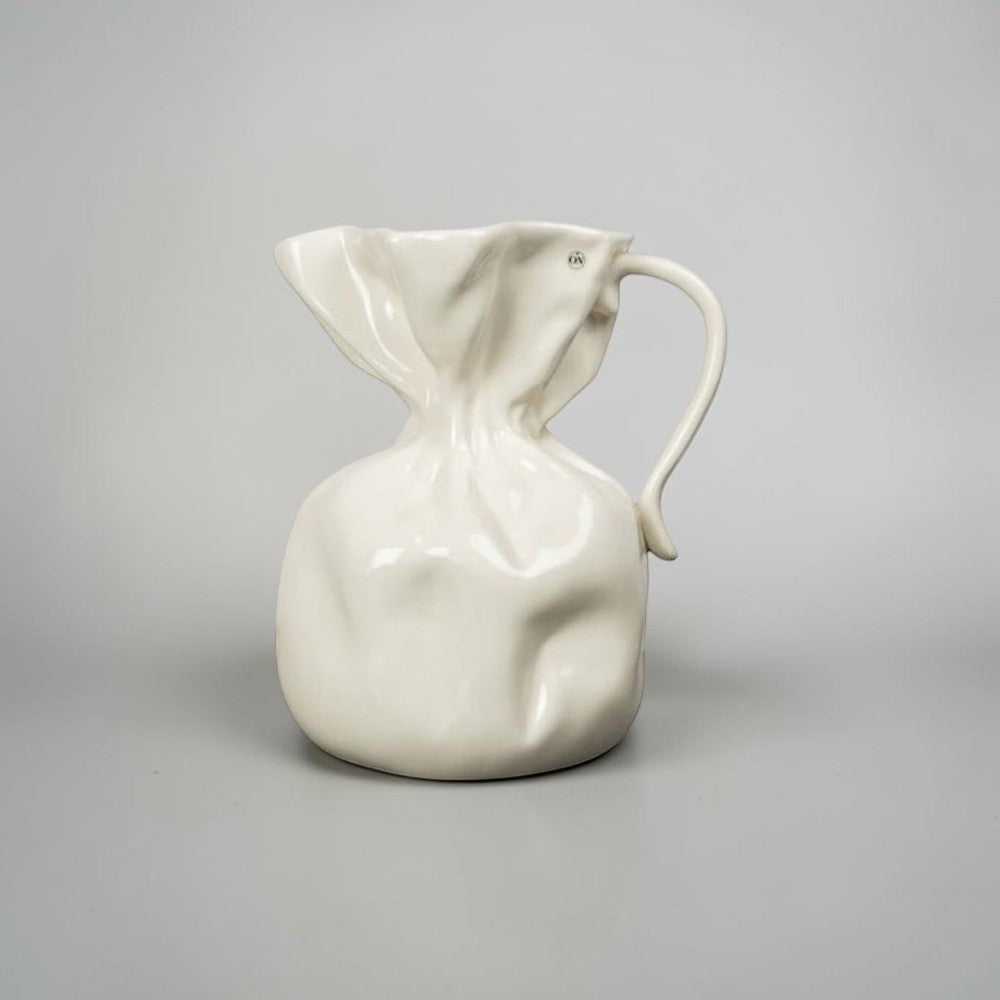 aelgmark Crumple white ceramic vase with a crumpled paper design and a curved handle.