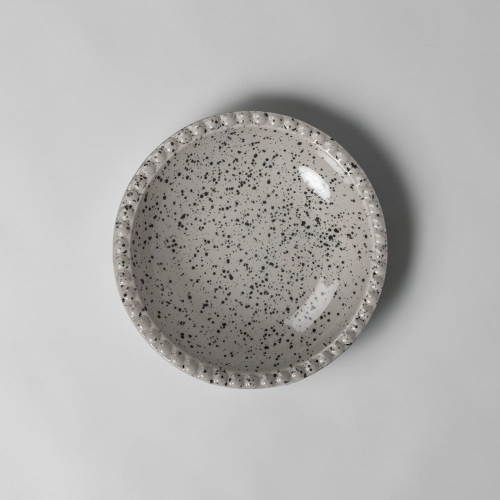 Aelgmark Ditte 26cm stoneware deep plate in beige/grey with black speckle pattern and beaded rim.