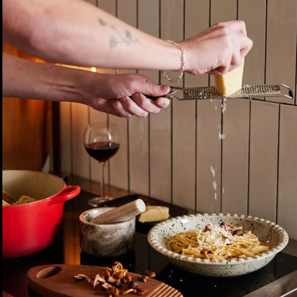 aelgmark Ditte 26cm stoneware serving bowl with speckled black pattern, perfect for pasta or salad.