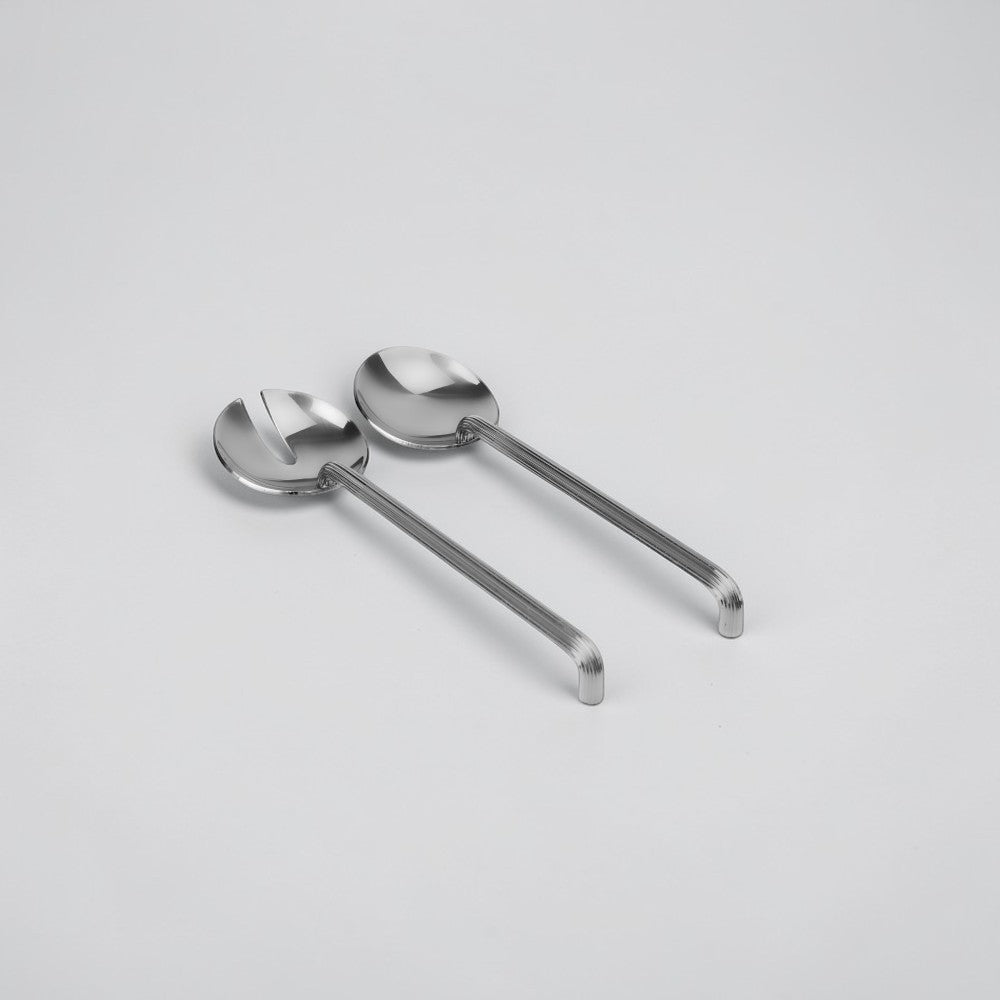 aelgmark Estelle stainless steel salad servers with ribbed handles and a unique design to rest on the edge of bowls.