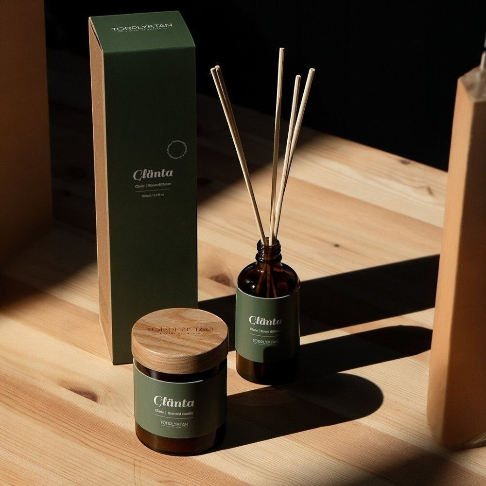 aelgmark Glade room diffuser with cedar, vetiver, sandalwood, bergamot, apple, and cherry notes. Amber glass bottle with reeds.