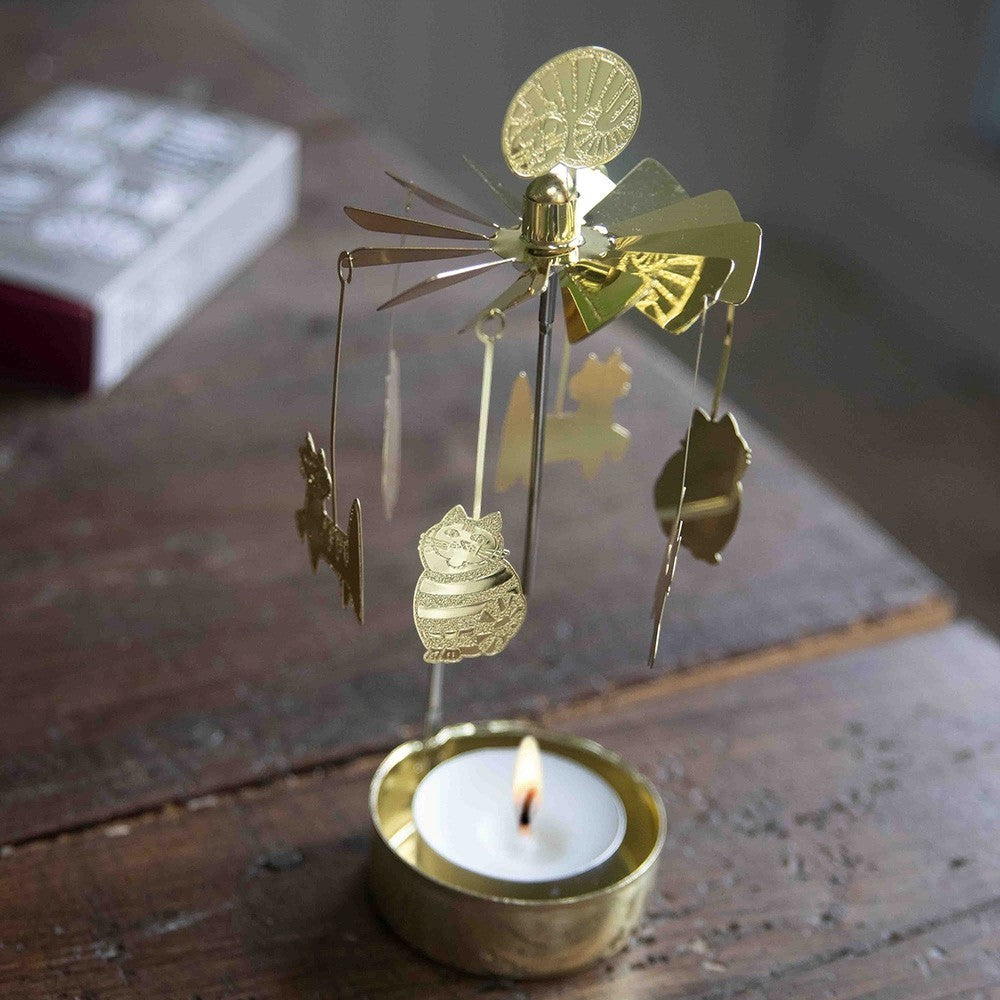 aelgmark gold cat spinning candle holder with decorative cat figures and a lit tea light.