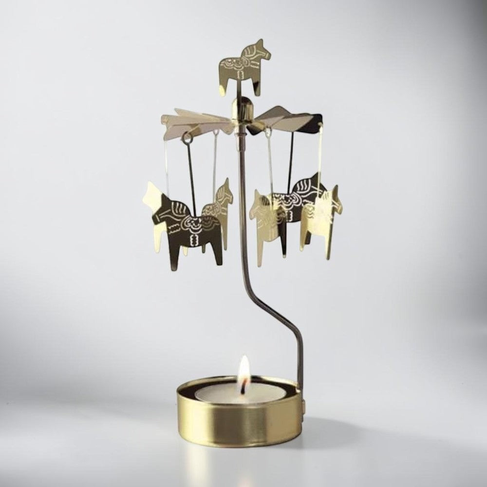 aelgmark gold Dala horse spinning candle holder with decorative horses and tealight.