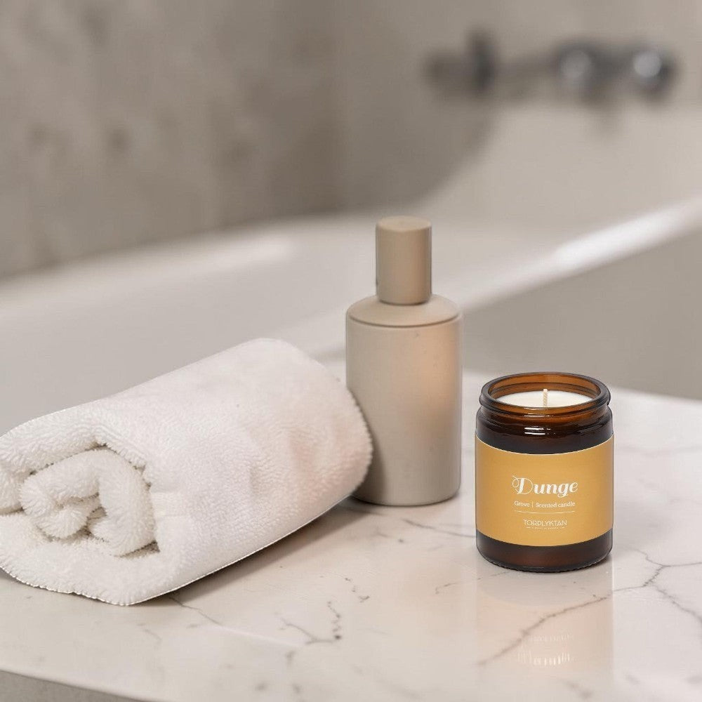 aelgmark Grove scented candle in amber glass jar with gold label, featuring violet, sage, and orchid scents.