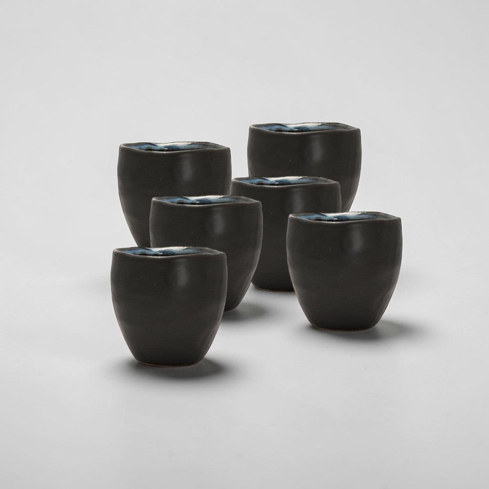 aelgmark Guilia black ceramic tea cup with blue glazed interior, 150ml, handmade with unique wavy rim.