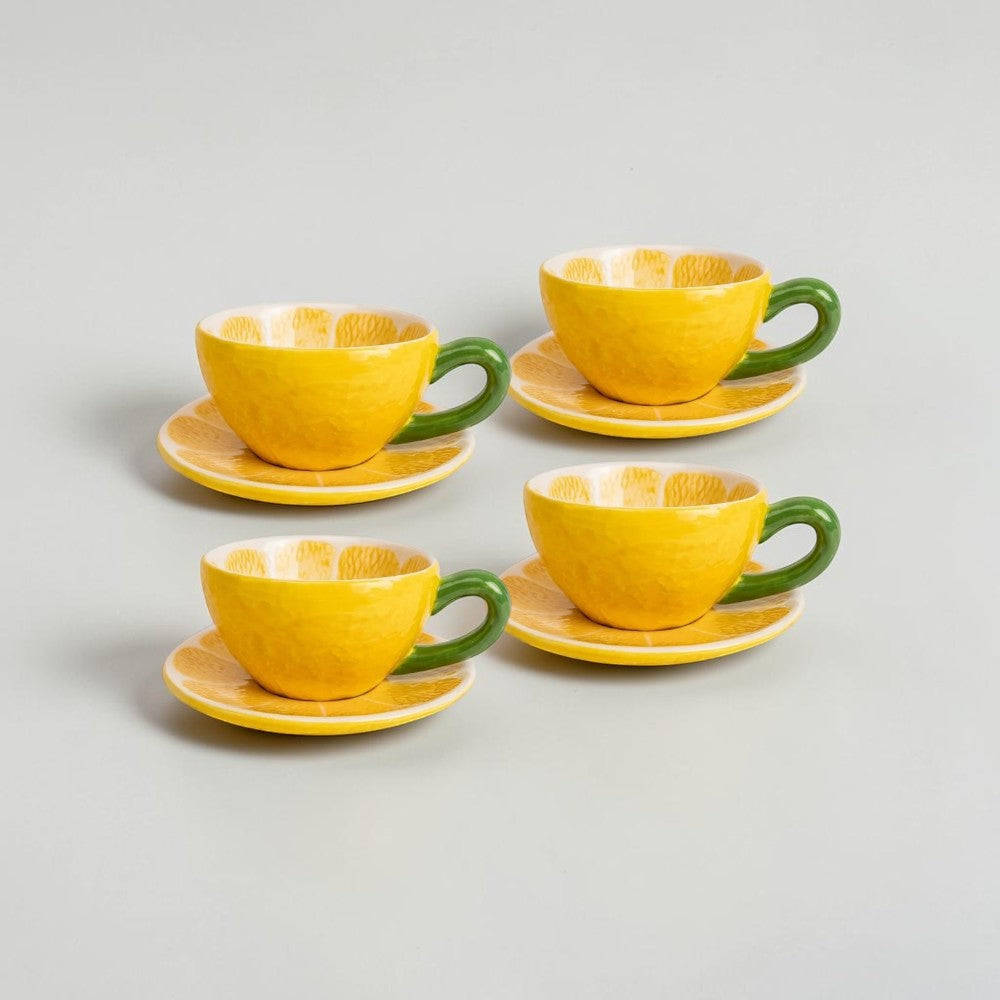 aelgmark lemon-shaped yellow ceramic teacup and saucer set with green handle, interior features citrus slice design.