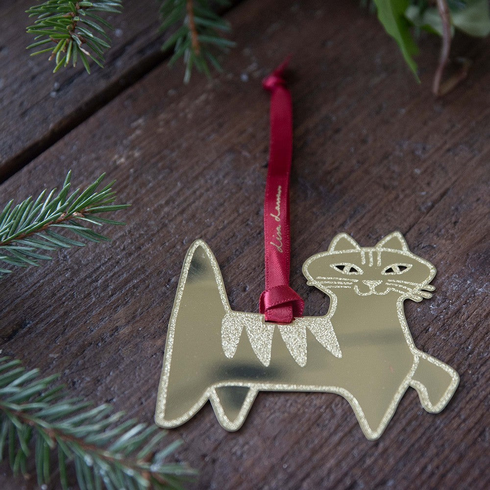 aelgmark Lisa Larson Felix cat ornament, gold metal with glitter stripes and red ribbon.
