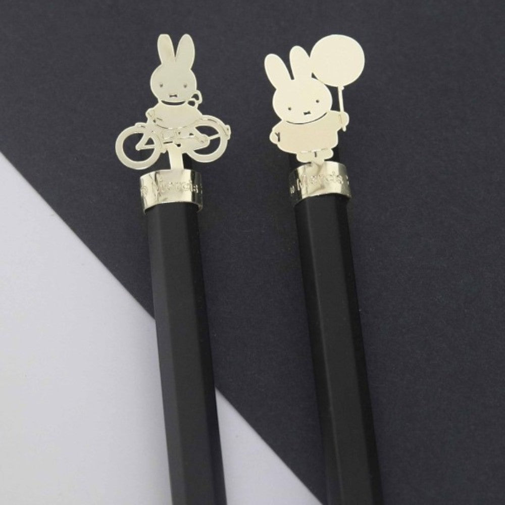 aelgmark black pencils with gold Miffy bunny charms, one riding a bicycle, one holding a balloon.