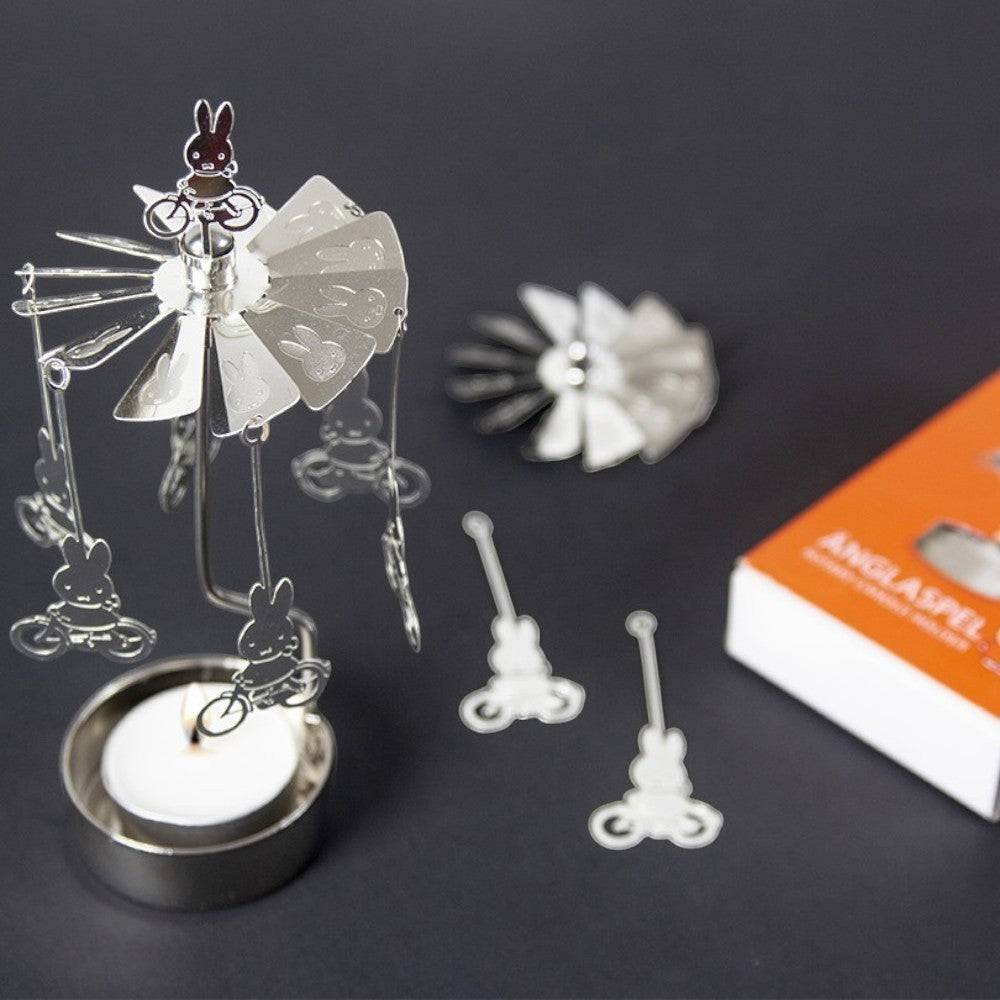 aelgmark Miffy bunny rotating candle holder with hanging charms and a lit candle. Silver metal.