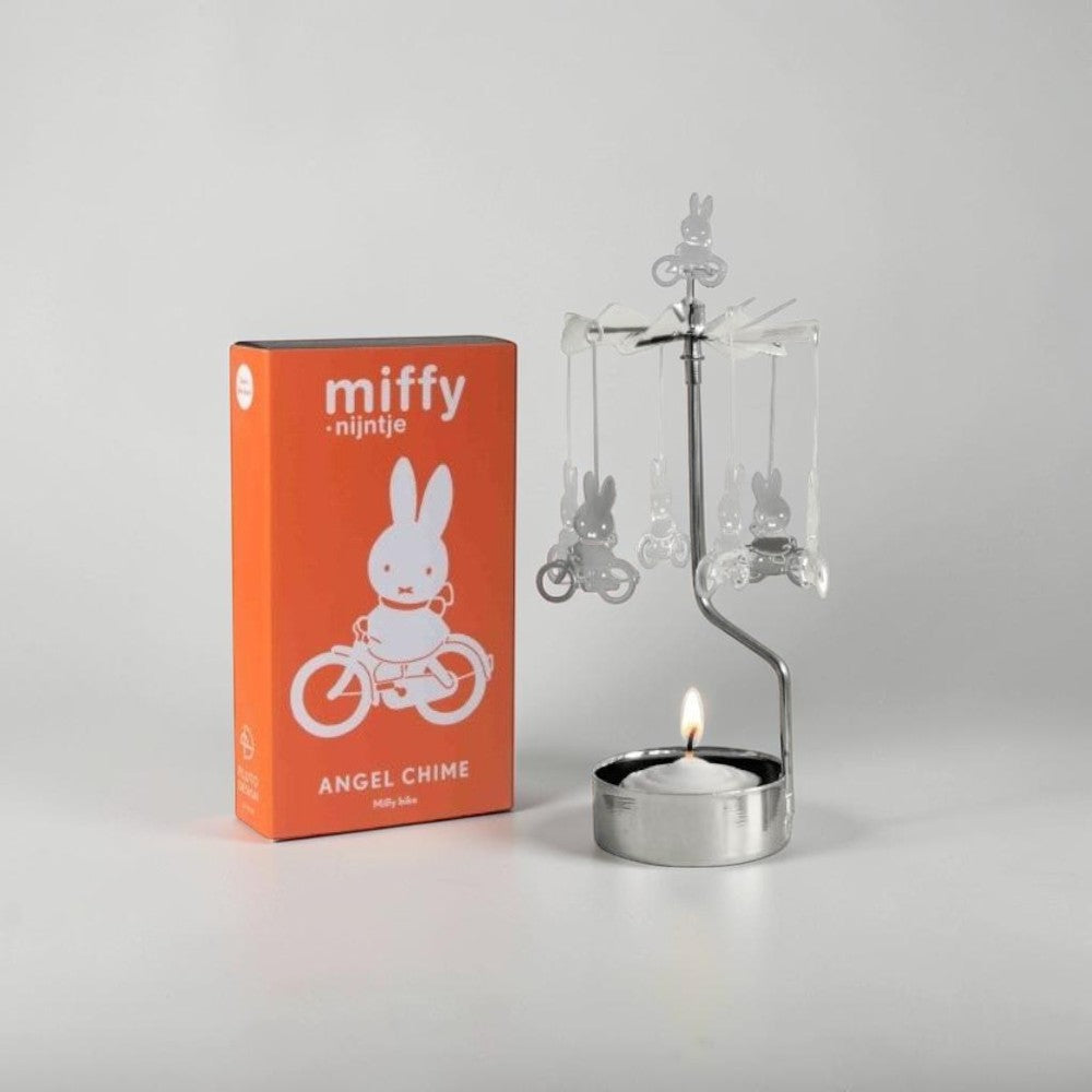 aelgmark Miffy bunny spinning candle holder with a lit tea light and Miffy figures on bicycles.