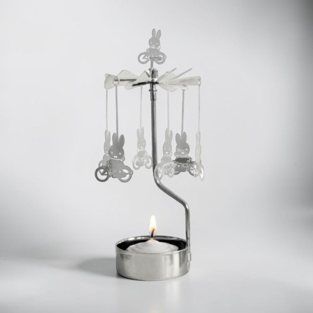 aelgmark Miffy bunny spinning candle holder with a lit tea light and Miffy figures on bicycles.