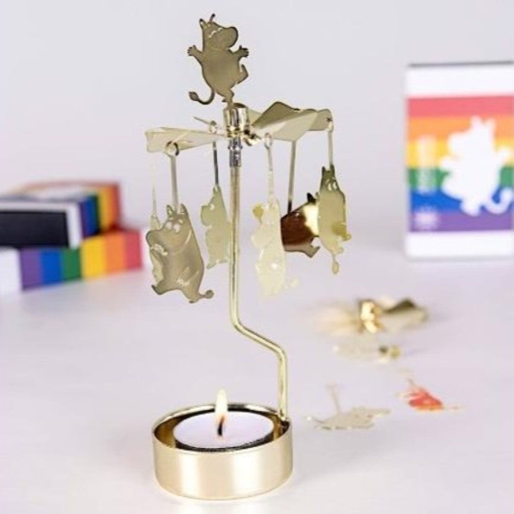 aelgmark Moomin rotating candle holder with gold metal finish and Moomin characters. Includes a lit tea light.