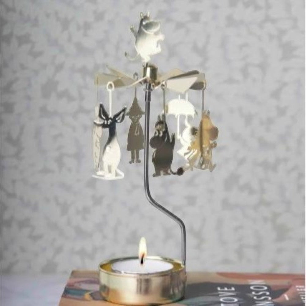 aelgmark Moomin characters rotating candle holder with a lit tea light, made of gold-tone metal.