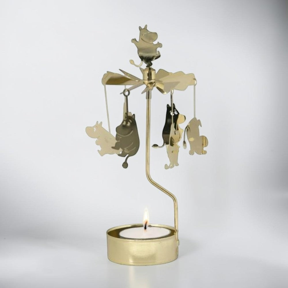 aelgmark Moomin spinning candle holder with gold metal Moomin characters hanging and rotating above a lit tea light.