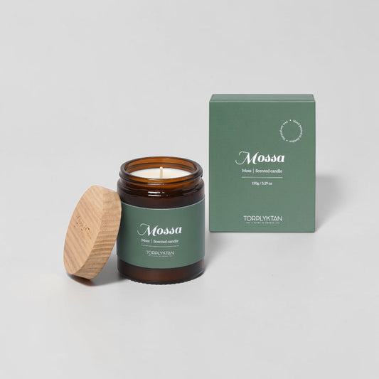 aelgmark Mossa scented candle in amber glass jar with wooden lid, moss scent with pine, patchouli, cedar notes.