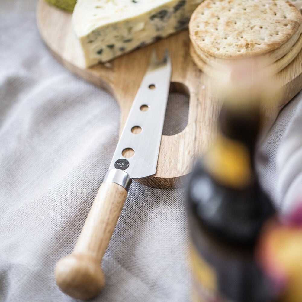aelgmark Nature oak handle cheese knife with stainless steel blade and holes, perfect for serving cheese boards.