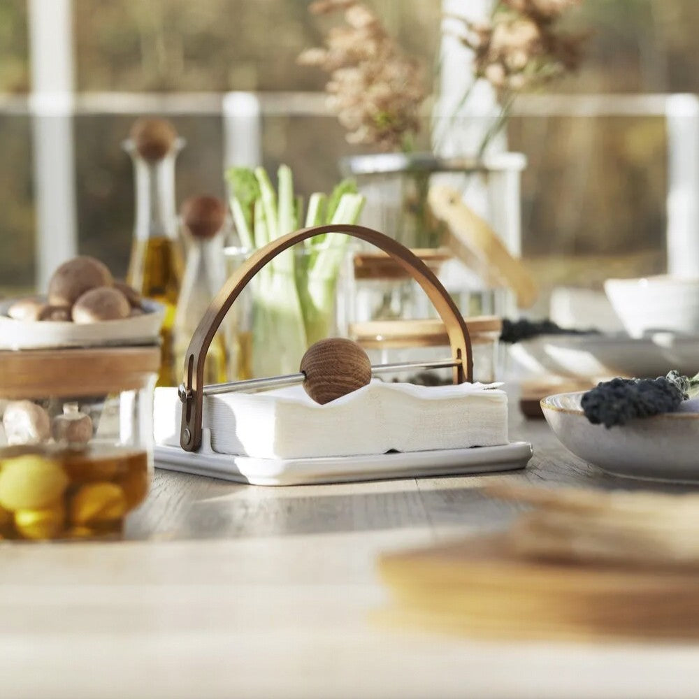 aelgmark Nature oak napkin holder with a stoneware base and wooden ball accent. Modern Nordic design.