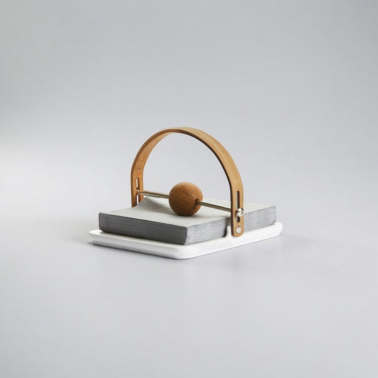 aelgmark Nature oak napkin holder with a white stoneware base and a wooden ball to secure napkins.