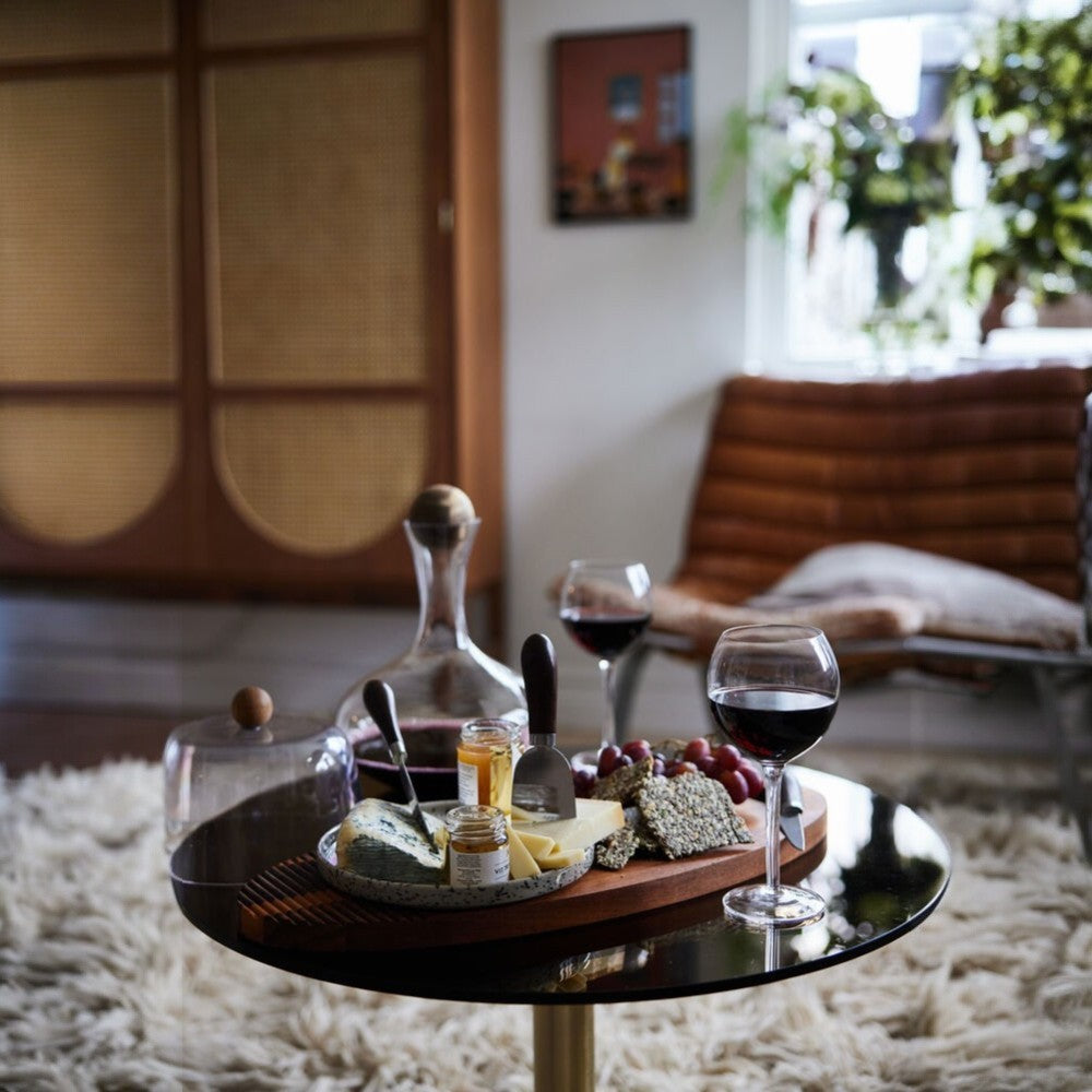 aelgmark oval acacia wood serving board with cheese, crackers, grapes, and wine.