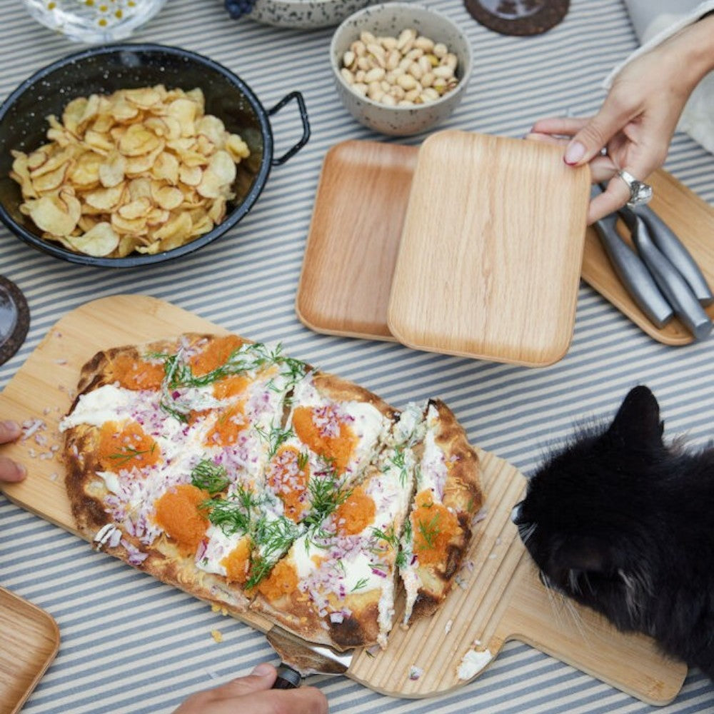 aelgmark oval bamboo serving board with groove for utensils, ideal for bread or cheese platters.