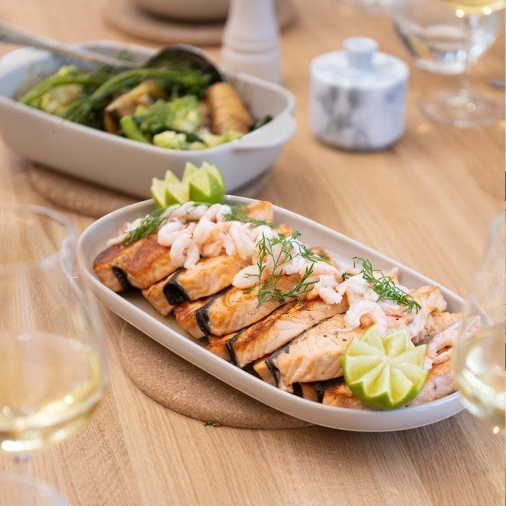 aelgmark oval ceramic serving platter with grilled salmon, shrimp, dill, and lime wedges